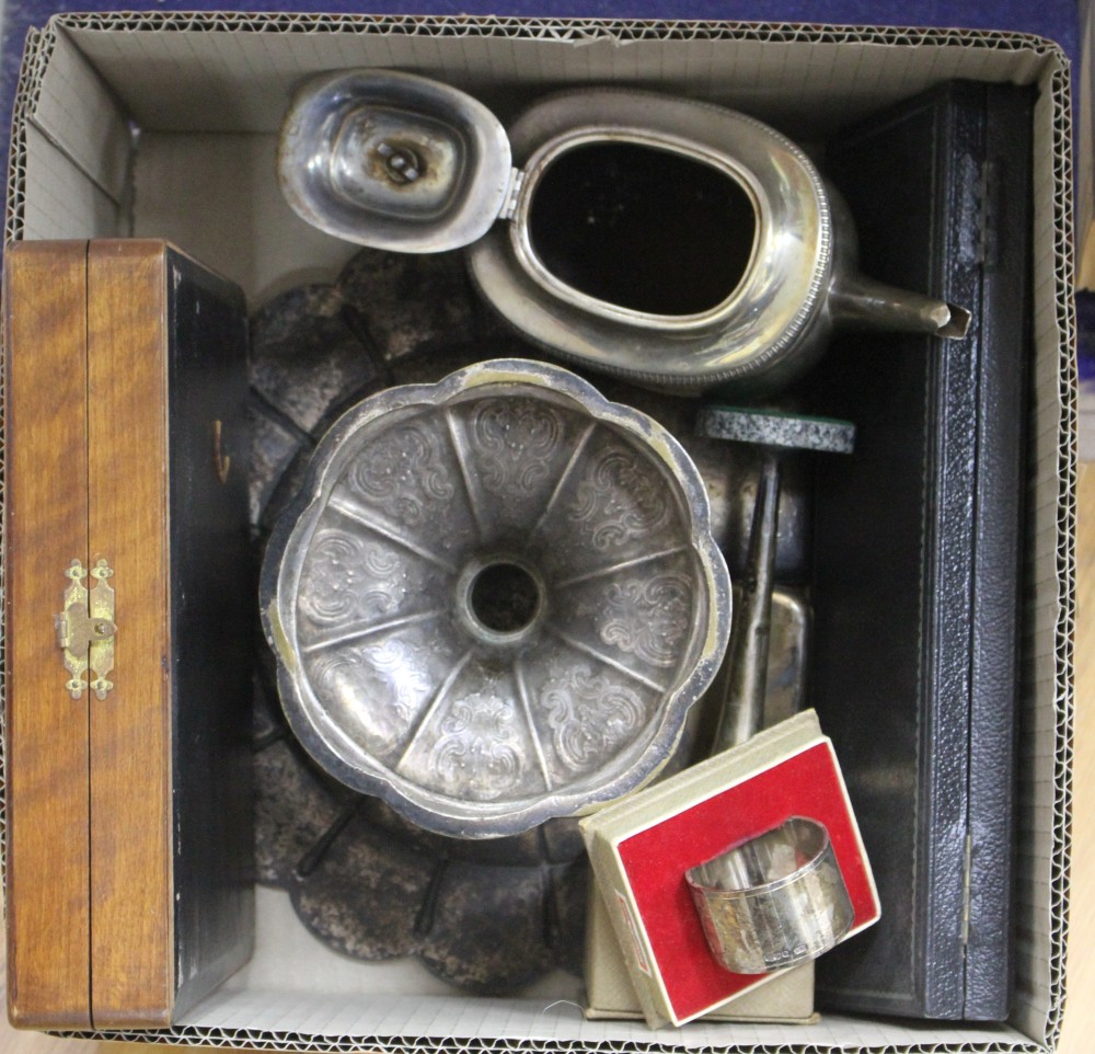 A silver teapot(a.f.) two silver cigarette cases(one a.f.), two cased silver napkin rings and four other items.